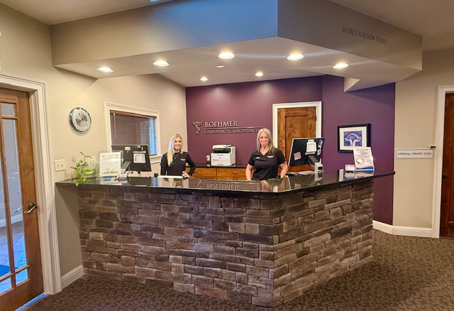 Chiropractic Columbia MO Standing behind desk